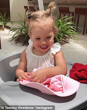 Over the years: The mother of two also uploaded photos of Saskia bathing in the sink and sitting in a high chair (pictured)