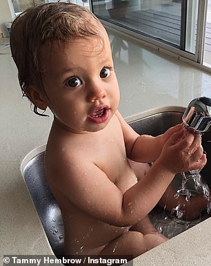 Over the years: The mother of two also uploaded photos of Saskia bathing in the sink (pictured) and sitting in a high chair (right)