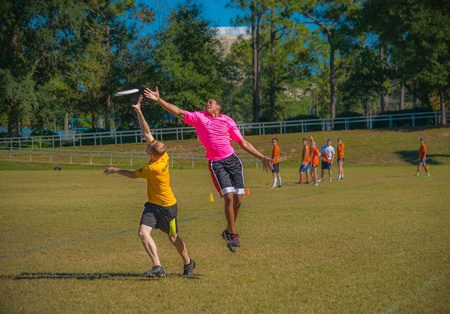 Ultimate frisbee game jumping to catch disc