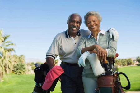 senior couple playing golf together